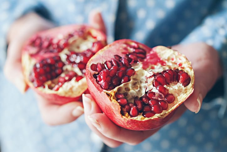 pomegranate in woman's hands