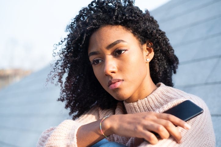 upset black woman with mobile phone