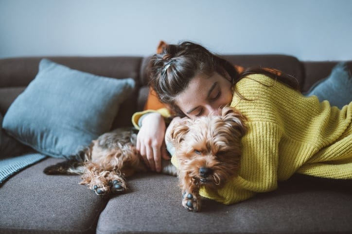 woman hugging yorkshire terrier