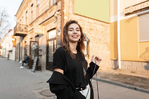 smiling woman walking on street