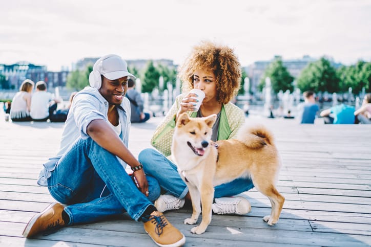 A couple out walking their dog.