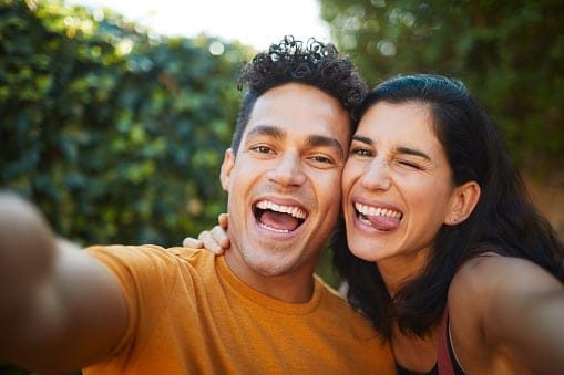 Boyfriend and girlfriend taking a selfie.