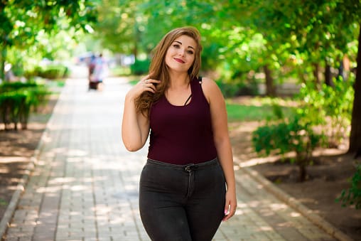 Single Young Pretty Plus Size Caucasian Happy Smiling Laughing Girl Woman, Walking In Summer Green Forest. Fun Enjoy Outdoor Summer Nature.