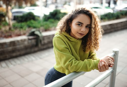 Teenager relaxing on city streets