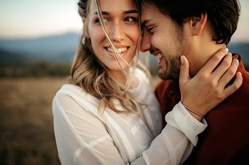 couple cuddling close outside