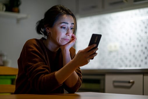 woman staring at phone