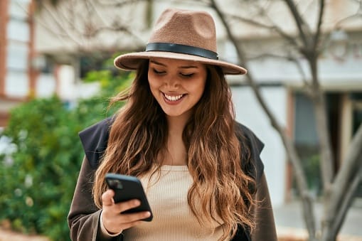 Young tourist woman using smartphone in the city.