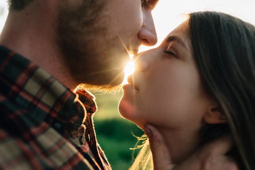 Kissing couple at sunset.
