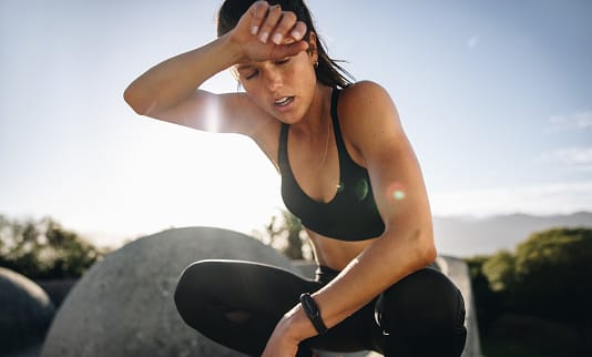 Tired woman resting after workout.