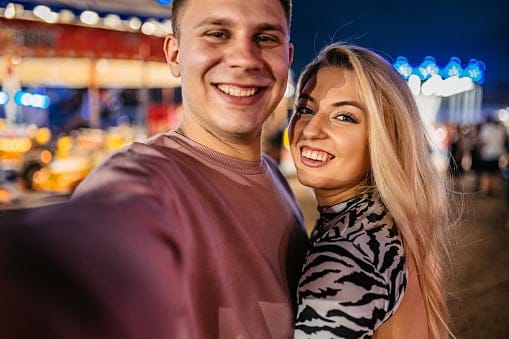 happy couple posing on night date