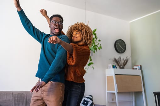Couple doing a happy dance.