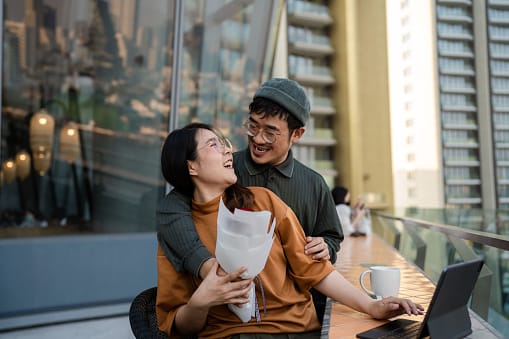 smiling gen z couple embracing outdoors