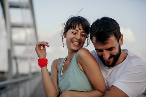 smiling couple embracing on rooftop