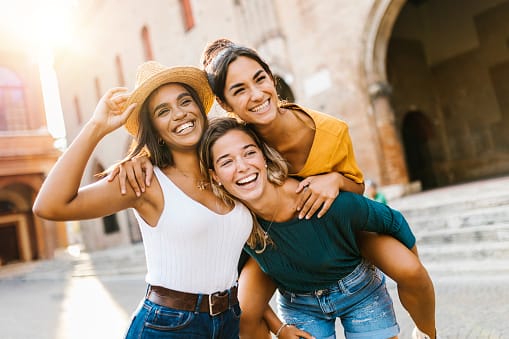 happy friends on city street
