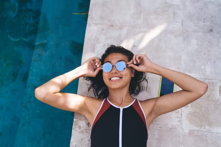 smiling woman laying by pool