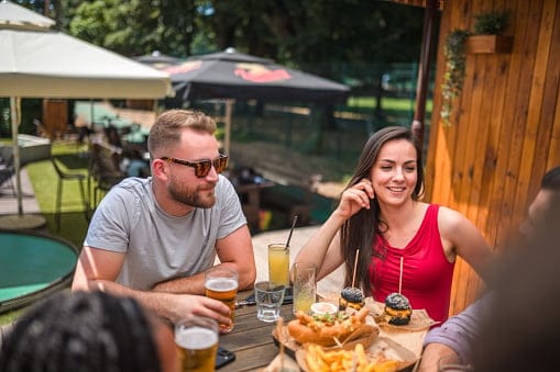 man and woman having lunch outside