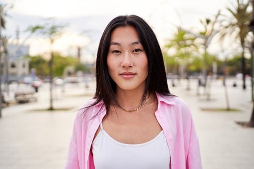 smiling asian woman outdoors