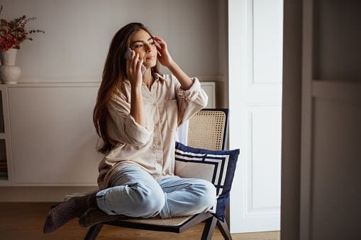 sad girl in chair by window