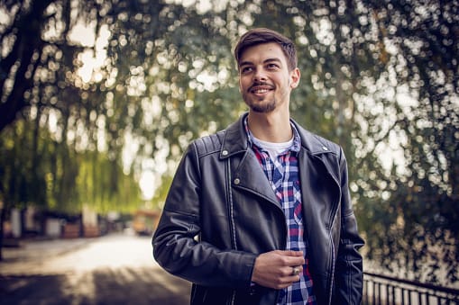 guy in leather jacket in park