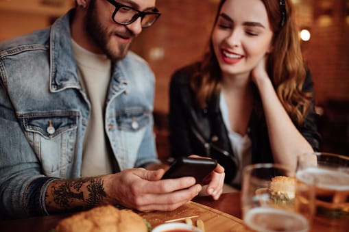Cute couple looking at social media on their phone