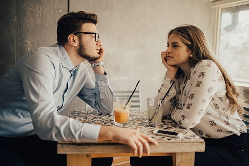 Teen couple drinking juice and having a date in the coffee bar