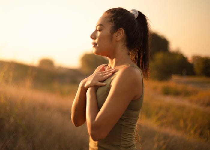 woman meditating during sunrise