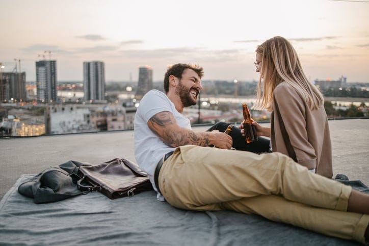 couple sitting by river on date