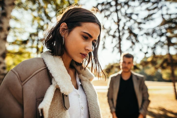 unhappy gen z couple in park