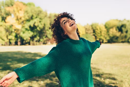 smiling woman basking in park
