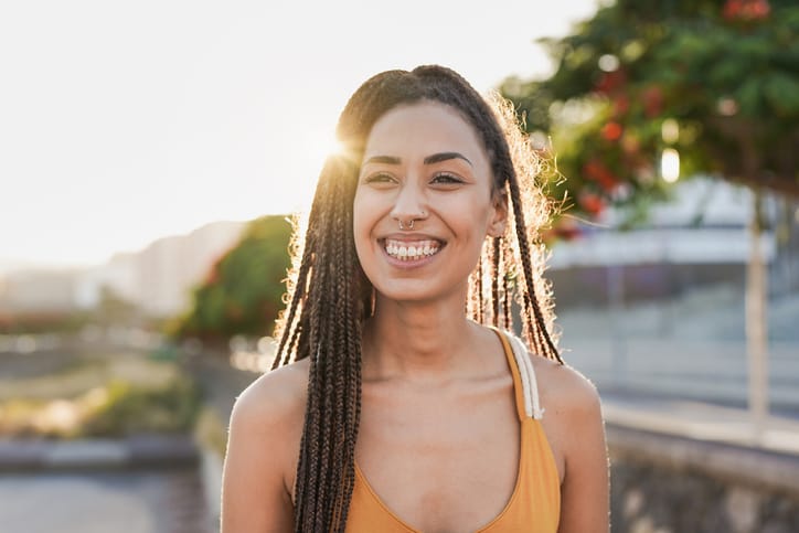 beautiful smiling woman outdoors in sunset
