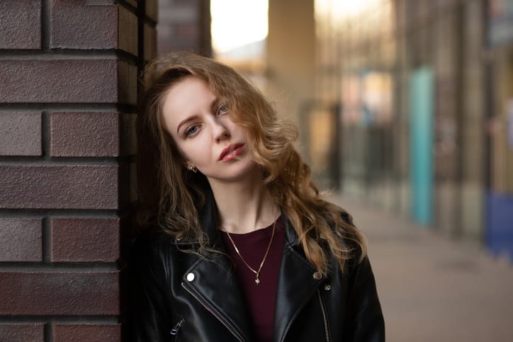frustrated woman leaning against wall