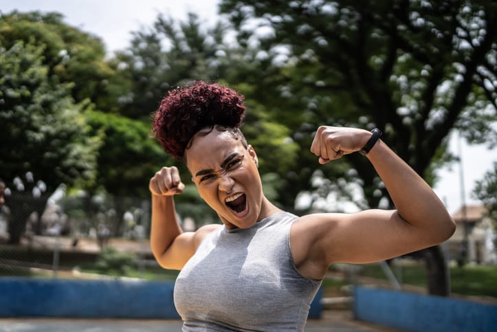 Strong woman flexing her muscles.