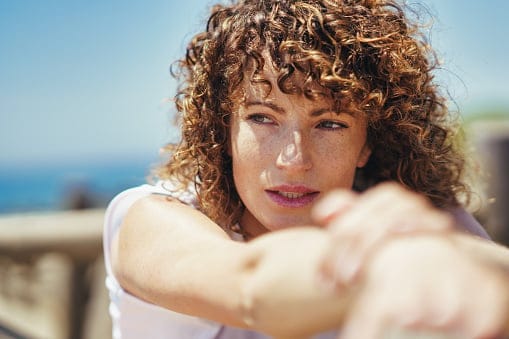 Woman with curly hair.