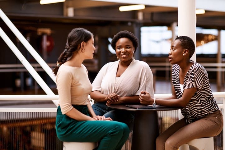 Three work colleagues in a meeting.