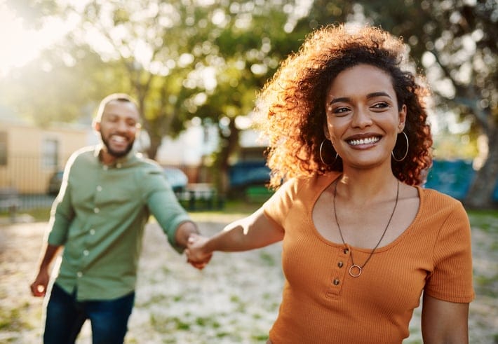 couple holding hands on sunny day