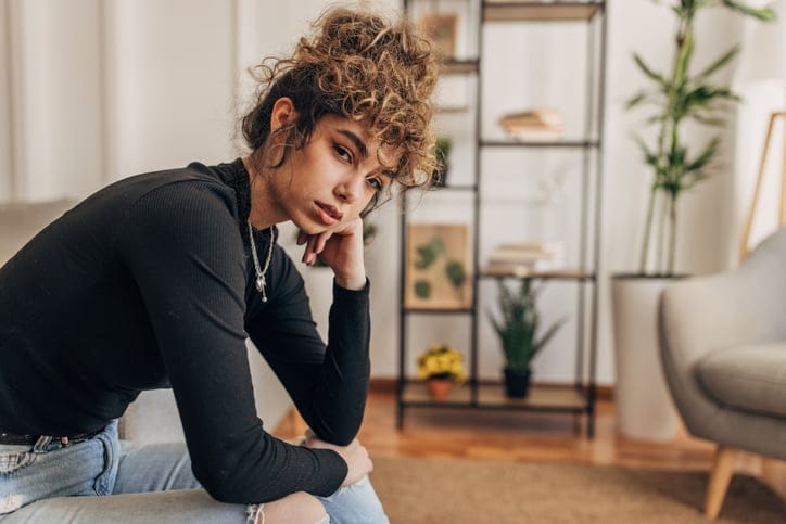 depressed young woman in her apartment