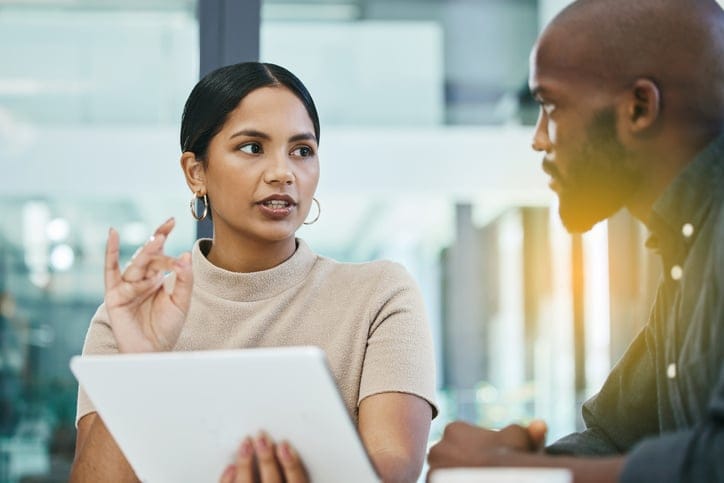 woman explaining concept to male colleague