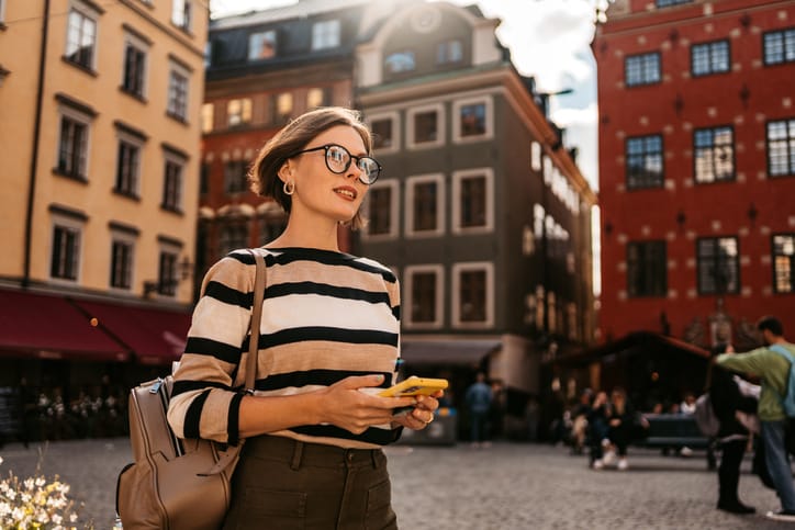 blonde woman walking in city