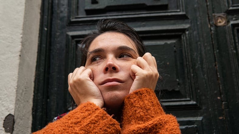 woman with hands on face
