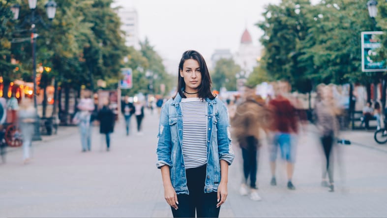 woman standing alone in a crowd