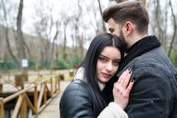 woman cuddling up to boyfriend on a winter day