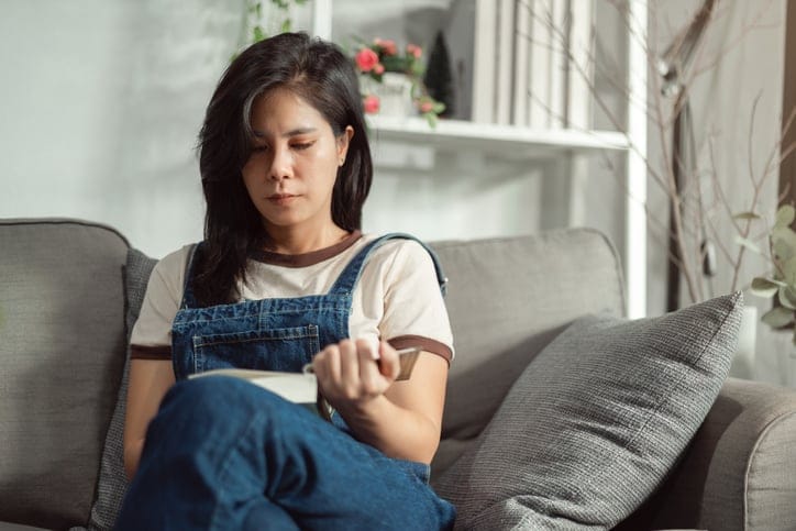woman on couch texting