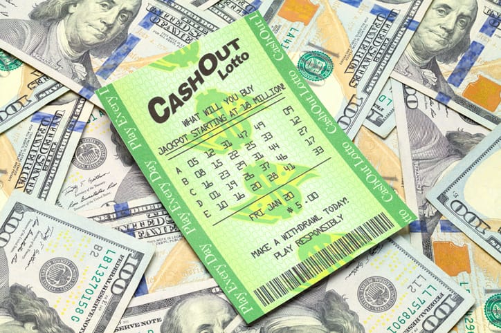 lottery ticket on top of cash