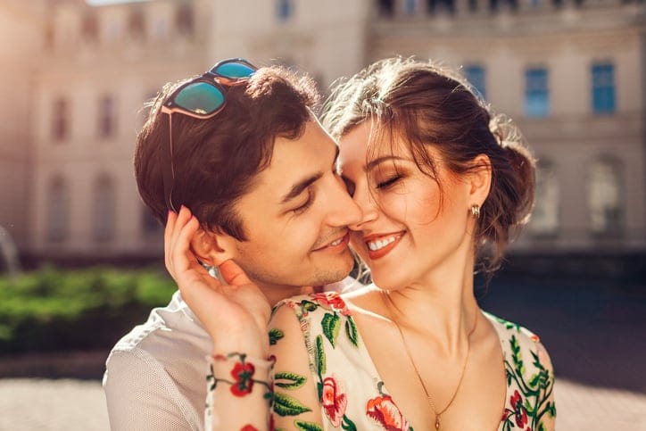 Romantic couple kissing on sunny day.