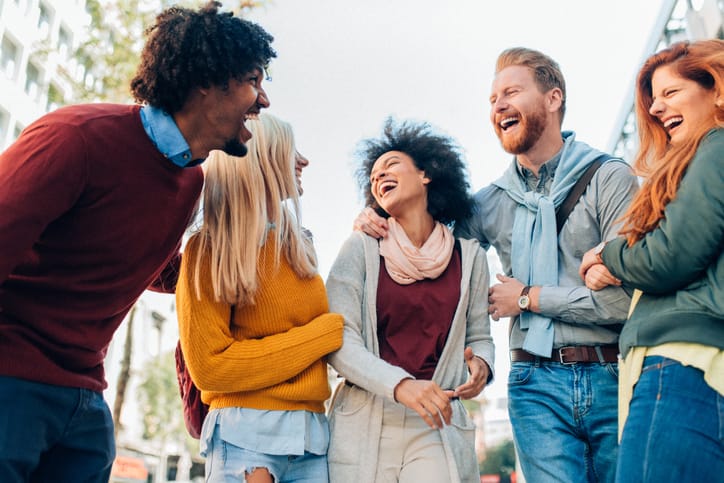 Group of multi-ethnic friends talking and laughing outdoor