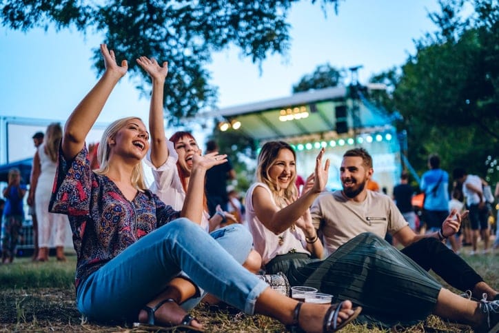 Group of young friends at a music festival.