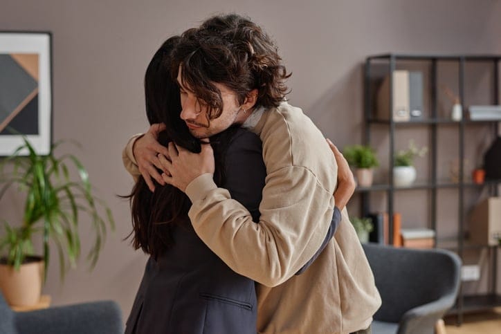man and woman hugging