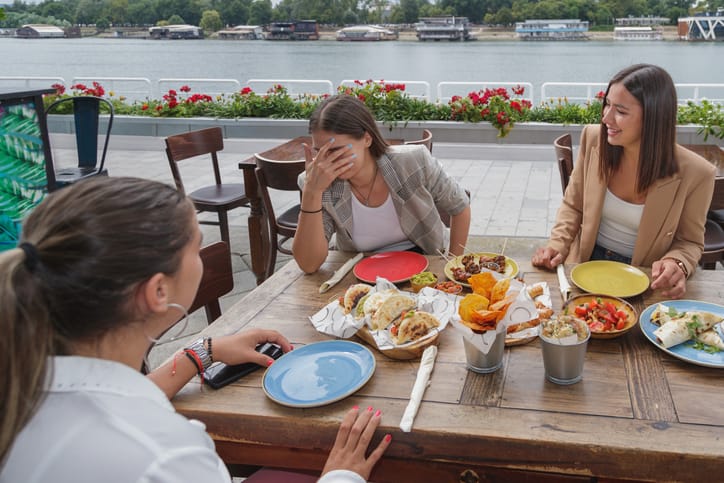 women chatting at outdoor cafe