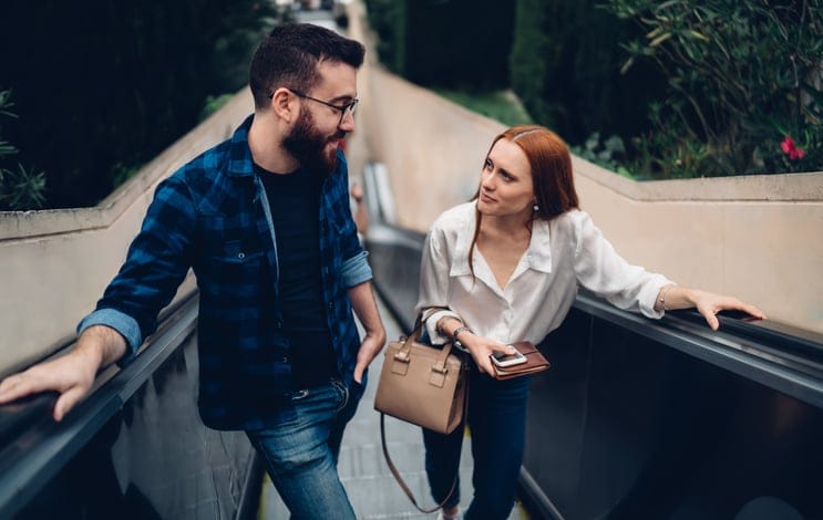couple riding escalator together