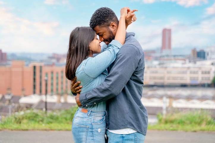 couple sharing romantic kiss outdoors